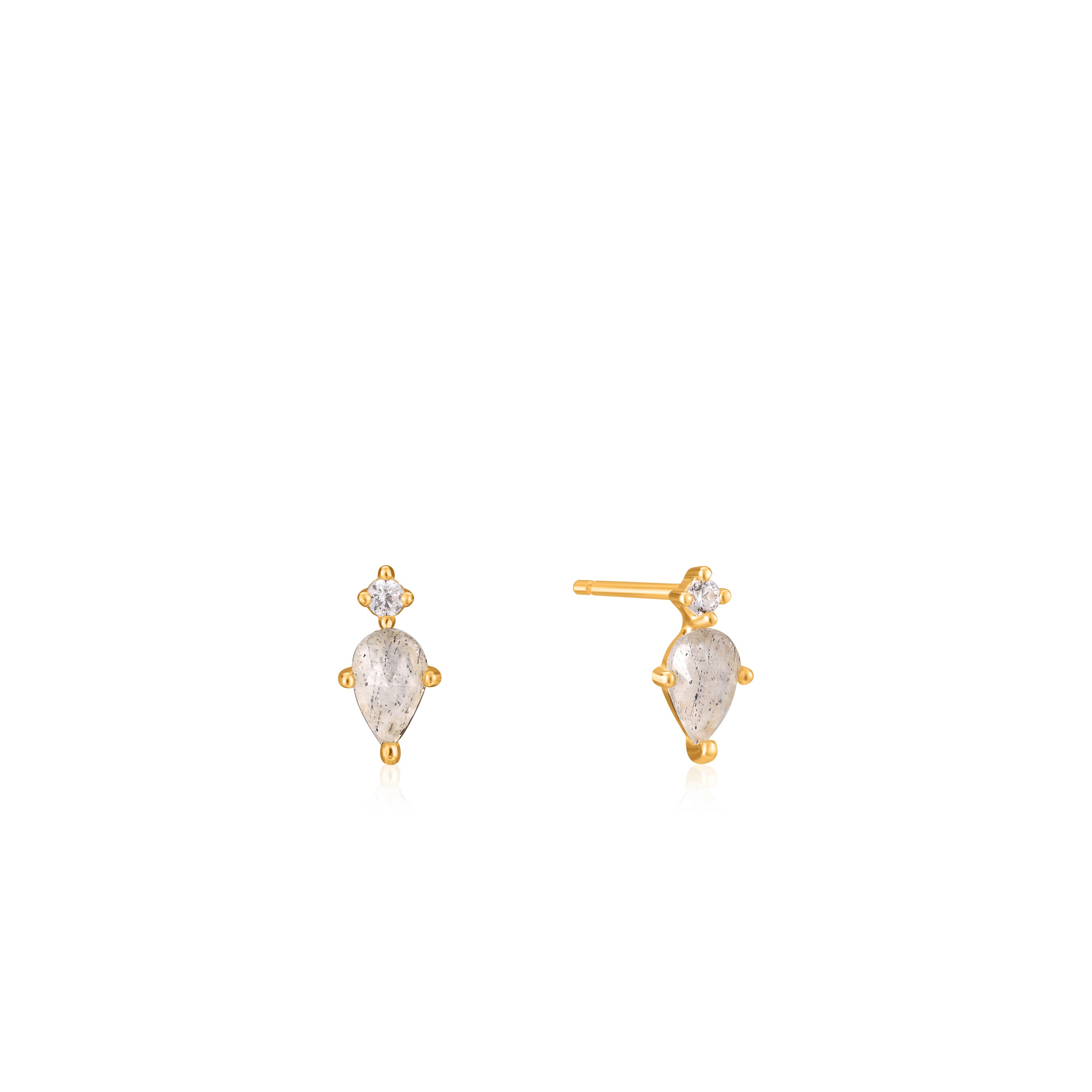 Die Ania Haie Ohrstecker - Midnight Fever bestehen aus 925er Sterlingsilber und zeigen einen teardrop-förmigen Mondstein mit kleinem rundem Edelstein, präsentiert von Ania Haie vor weißem Hintergrund.