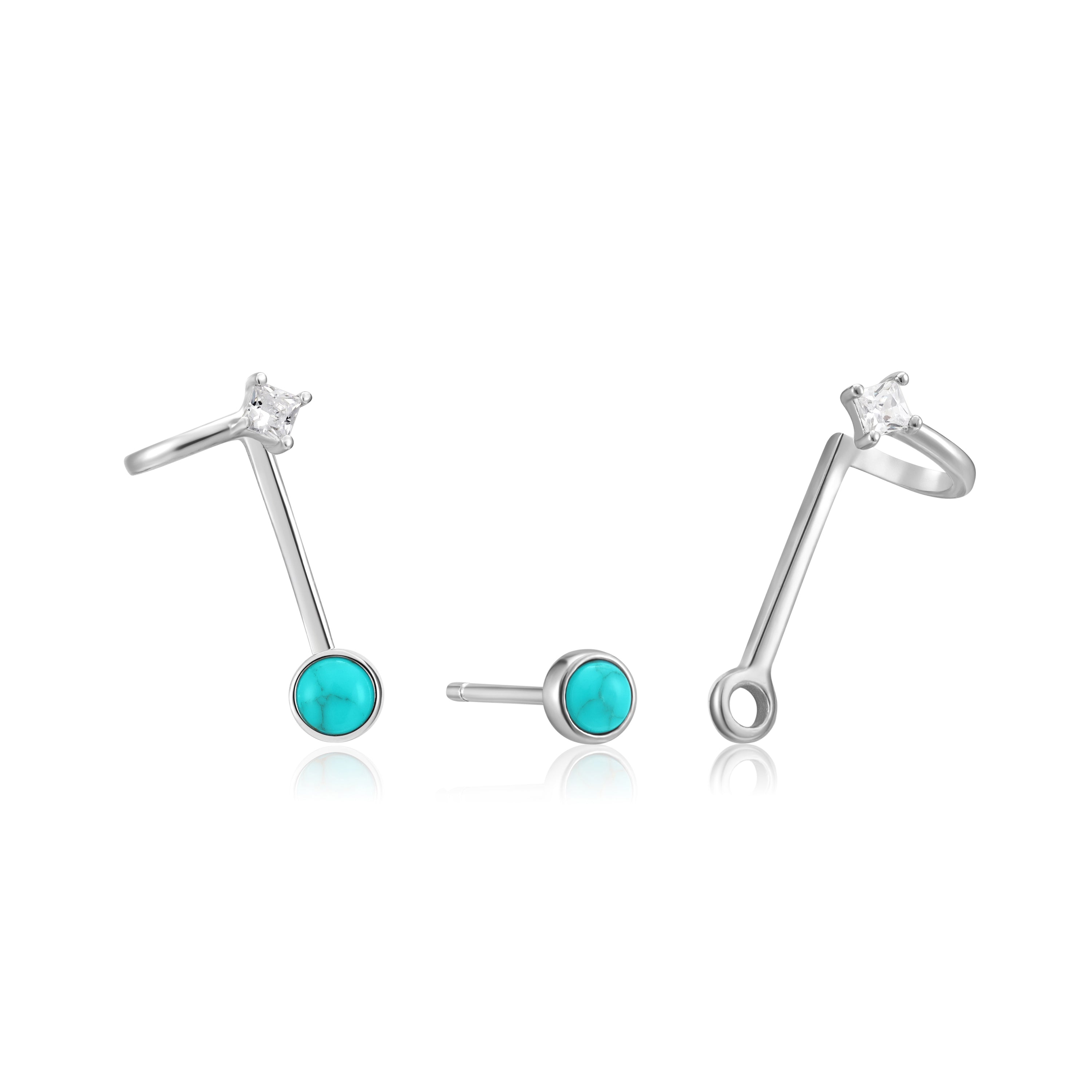 Drei Ania Haie Ohrstecker - Turquoise Hidden Gem 925er Sterlingsilber Ohrringe mit türkisfarbenen Steinen und klaren runden Ohrsteckern, dargestellt auf weißem Hintergrund. Marke: Ania Haie.