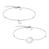 Das Tamaris Set - You & Me von Tamaris besteht aus zwei zarten Silberarmbändern - eines mit einem Herzanhänger, das andere mit einer runden Scheibe und einem Herzausschnitt - perfekt zum Übereinanderlegen und eine schöne Geschenkidee für jeden Anlass.