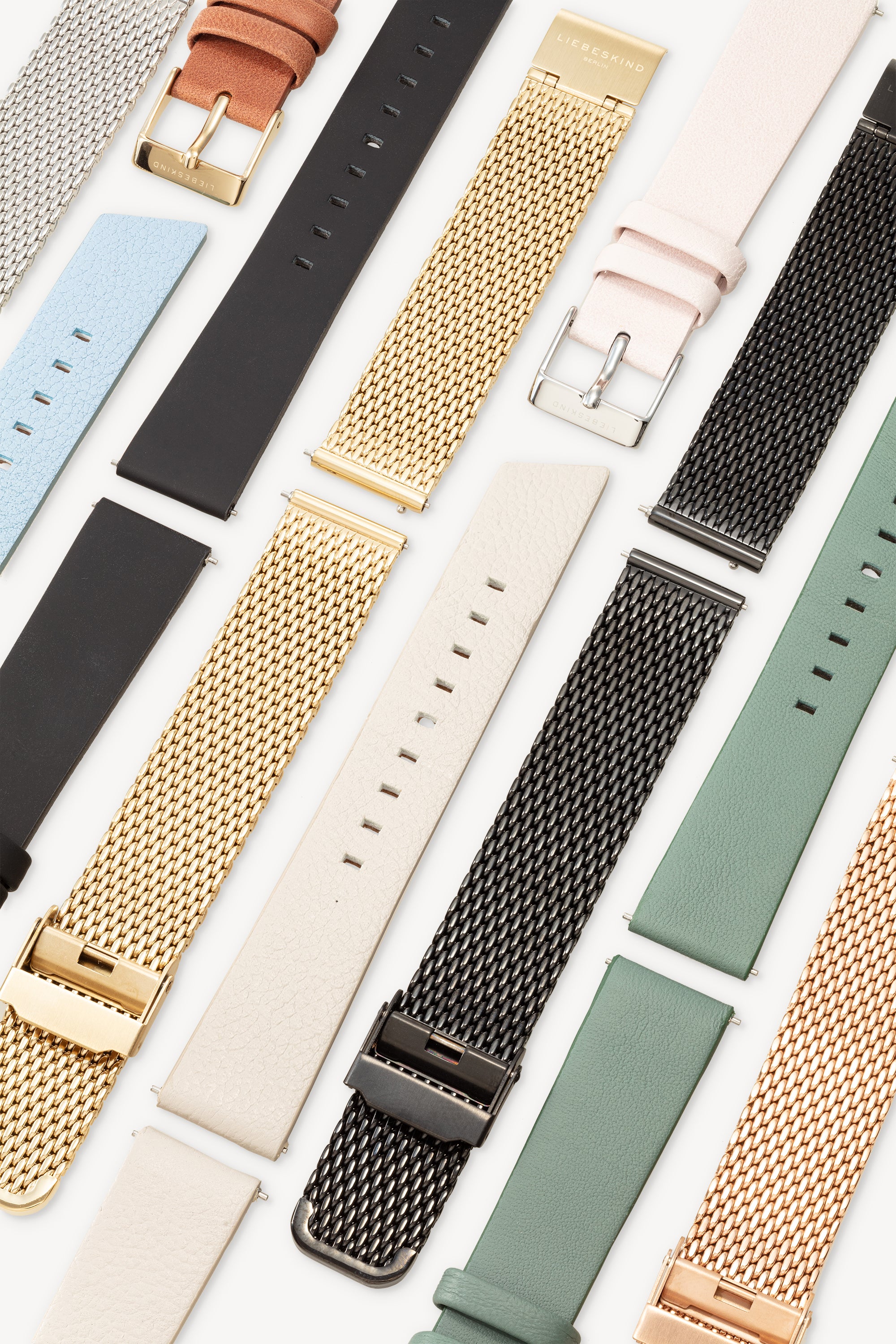 LIEBESKIND BERLIN Uhrenband - Easy Change Uhrenarmbänder von Liebeskind Berlin in verschiedenen Farben und Materialien sind in parallelen Reihen auf weißem Grund angeordnet.