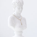 Weiße Marmorbüste einer Frau präsentiert die Echtzeit Halskette - The Sleek One von Echtzeit, eine goldene Halskette, die sich ideal für den trendigen Layering-Look eignet, vor einem schlichten weißen Hintergrund.