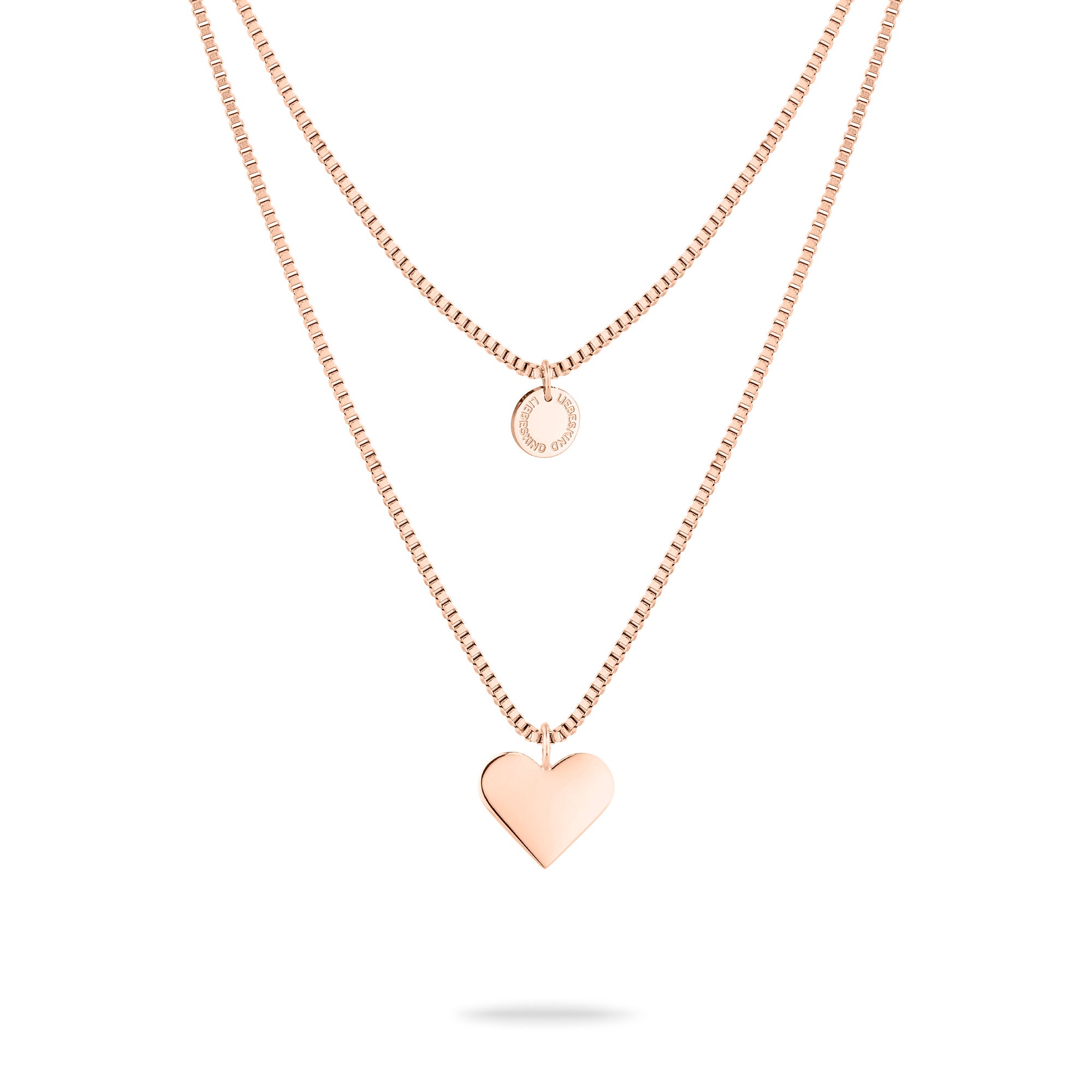 Die LIEBESKIND BERLIN Halskette - Layered Love von Liebeskind Berlin ist eine roségoldene Edelstahlkette mit zwei Lagen: einem kleinen Kreisanhänger und einem größeren Herzanhänger.