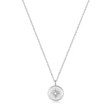 Die Ania Haie Halskette - The Star Coin Pendant besteht aus einer silbernen Kette und einem runden Sunburst-Anhänger mit einem zentralen Edelstein. Erleben Sie die Eleganz von Ania Haie mit dieser außergewöhnlichen Halskette.