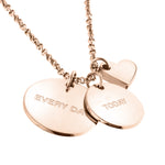 Liebeskind Berlin Halskette bestehend aus einer filigranen, roségoldenen Kette mit einem kleinen Herzanhänger und zwei gravierten, runden Plättchenanhängern; Nahaufnahme