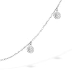 Die Tamaris Halskette - Coin ist eine filigrane silberne Ankerkette mit zwei kleinen runden Münz-Charms aus Edelstahl von Tamaris, die jedem Look auf weißem Hintergrund eine elegante Note verleiht.
