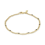 Das COPENHAGEN STUDIOS Armband - Glittery von Copenhagen Studios hat eine goldene Kette mit gleichmäßig verteilten kleinen schwarzen Steinen und einen sicheren Karabinerverschluss.