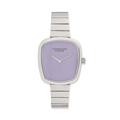 COPENHAGEN STUDIOS Armbanduhr - Curved Watch: Elegante silberne Damenuhr von Copenhagen Studios mit anmutigem lavendelfarbenem Zifferblatt und charakteristischem Branding.