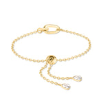 Echtzeit Armband - Wie Diamanten: Goldkettenarmband von Echtzeit mit Verschluss und zwei baumelnden Enden, die jeweils mit einem tropfenförmigen Kristall verziert sind.