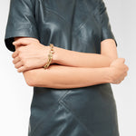 Liebeskind Berlin Armband bestehend aus einer goldenen, groben Gliederkette und einem Herzanhänger mit grafischen Elementen; Tragebild