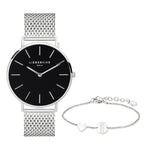 Das Liebeskind Berlin Set - Lovely Silver Basic kombiniert eine silberne Uhr mit schwarzem Zifferblatt und ein feines Armband mit Herzanhänger - das ideale Accessoire für elegante Damen.
