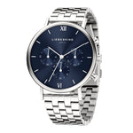 Die LIEBESKIND BERLIN Armbanduhr - Modern Chronograph hat ein silbernes Metallband, ein blaues Zifferblatt mit drei Hilfszifferblättern und zeigt die Eleganz der Marke Liebeskind Berlin.
