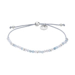 Das Tamaris Set - Blue Combination von Tamaris besteht aus einem hellblauen, verstellbaren Perlenarmband mit einem silbernen Anhänger an einer grauen Kordel - ein elegantes Accessoire, das Sie mit Ihrer Lieblings-Edelstahluhr Damen kombinieren können. Dargestellt auf weißem Hintergrund.
