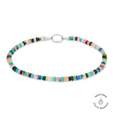Die Tamaris Fußkette - All About Beads von Tamaris besteht aus bunten Perlen und einer silbernen Schließe, die in einem Kreis auf weißem Hintergrund angeordnet sind.