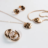 Das Schmuckset Tamaris Creole - Little Twinkle von Tamaris bietet Mond- und Sterndesigns mit Zirkoniasteinen, darunter elegante Ohrringe, Halsketten und Ringe, die alle auf weißem Hintergrund präsentiert werden.