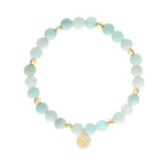 Tamaris Armband Modern Turquoise mit türkisfarbenen Perlen, goldfarbenen Kugeln und rundem Anhänger mit Logomotiv