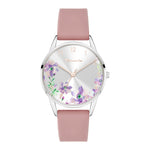Die Tamaris Armbanduhr - The Flower hat ein rosafarbenes Silikonarmband, ein silbernes Zifferblatt, elegante goldene Indexe und einen charmanten lilafarbenen Blumenprint.