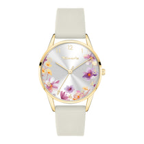 Die Tamaris Armbanduhr - The Flower verfügt über ein goldenes Gehäuse, ein cremefarbenes Silikonarmband und ein Zifferblatt mit einem leuchtenden lila und gelben Blumendruck, der die Eleganz von Tamaris verkörpert.