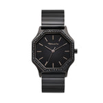 Die Tamaris Armbanduhr - Sparkling Octavia hat ein schwarzes, achteckiges Gehäuse, ein minimalistisches Zifferblatt mit dem Tamaris-Logo und ein elegantes Edelstahlarmband.