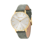 Die Tamaris Armbanduhr - Stamped Flowers hat ein goldenes Gehäuse, ein weißes Zifferblatt, ein grünes Wildlederarmband und minimale goldene Markierungen und Zeiger - eine stilvolle Tamaris-Uhr, die jedes Outfit aufwertet.